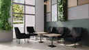 Black Oslo Scandinavian fabric reception chair by Nautilus Designs with sleek wooden legs, modern and comfortable for office waiting areas.