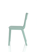 Dynamic Nest Edge stacking cafe and bistro chair with a sleek design, shown in a natural outdoor setting.