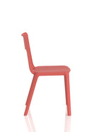 Dynamic Nest Edge stacking cafe and bistro chair with wooden frame and woven seat, shown in a natural outdoor setting.