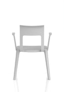 Dynamic Nest Edge stacking cafe and bistro chair with arms, shown in a natural outdoor setting