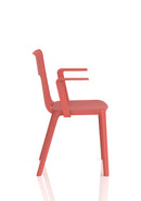 Dynamic Nest Edge stacking cafe and bistro chair with arms, shown in a modern outdoor setting.