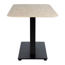 ZAP Extrema Premium dining table with beige travertine tabletop and black Anzio base, shown from side view.