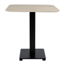 ZAP Extrema Premium dining table with beige travertine tabletop and black Anzio base, square design, viewed from the side.