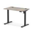 Gray oak Air Lite height adjustable slimline desk by Dynamic with cable ports, showcasing its modern design and adjustable features.