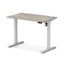 Dynamic Air Lite height adjustable slimline desk in grey oak finish with cable ports and modern design.