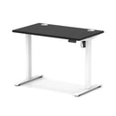 Dynamic Air Lite height adjustable slimline desk in black with cable ports, featuring a modern design and sleek black finish.