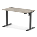 Dynamic Air Lite height adjustable slimline desk in grey oak with cable ports, featuring a modern design and sleek finish.