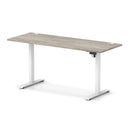 Dynamic Air Lite height adjustable slimline desk in grey oak finish with cable ports and modern design.