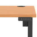Dynamic Air Lite height adjustable desk in beech finish with cable ports and sleek modern design.