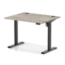 Dynamic Air Lite height adjustable desk in grey oak finish with cable ports, showcasing a modern ergonomic workspace solution.