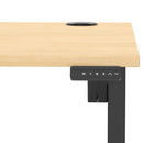 Dynamic Air Lite height adjustable desk with maple finish and cable ports, featuring a sleek, modern workspace design.