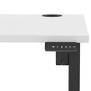 White Air Lite height adjustable desk by Dynamic with cable ports, featuring a sleek modern design and ergonomic workspace.