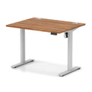 Dynamic Air Lite height adjustable desk with walnut finish and cable ports, showcasing a modern ergonomic workspace solution.
