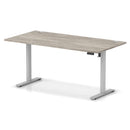 Dynamic Air Lite height adjustable desk in grey oak finish with cable ports and modern design.