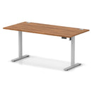 Dynamic Air Lite height adjustable desk with walnut finish, featuring cable ports and modern ergonomic design