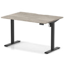 Dynamic Air Lite height adjustable desk with scalloped edge in grey oak finish, showcasing its sleek modern design and adjustable height feature.