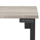 Dynamic Air Lite height adjustable desk in grey oak finish with scalloped edge, showcasing a modern ergonomic workspace solution.