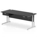 Black Impulse cantilever straight desk by Dynamic with two fixed pedestals and one drawer, shown from a front angle.