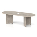 Grey oak Impulse Volta boardroom table with arrowhead legs and pop-up power module by Dynamic, shown in a modern conference room setting.