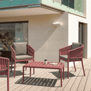 ZAP Portofino stacking armchair with a sleek design, shown insitu with a woven seat and modern wooden frame in a stylish outdoor setting.