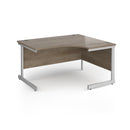 Dams Contract 25 ergonomic desk with Nebraska Oak finish and cantilever leg design, featuring a spacious workspace.