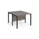 Dams Maestro 25 600mm deep back-to-back straight desks with bench legs in grey oak finish, showing the sleek tabletop design.