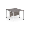Dams Maestro 25 600mm deep back-to-back straight desks with grey oak finish and bench leg design, ideal for office workspace.