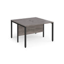 Dams Maestro 25 600mm deep back-to-back straight desks with bench leg in grey oak finish, showing the workspace setup and design.