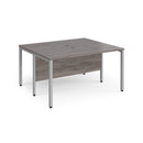 Dams Maestro 25 600mm deep back-to-back straight desks with bench legs in grey oak finish, showing the sleek workspace setup.