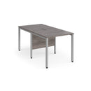 Dams Maestro 25 800mm deep back-to-back straight desks with bench leg in grey oak finish, showing the sleek workspace setup.