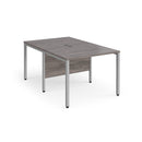 Dams Maestro 25 800mm deep back-to-back straight desks with bench legs in grey oak finish, ideal for office workspace setup.