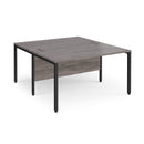 Dams Maestro 25 800mm deep back-to-back straight desks with bench legs in grey oak finish, showing the sleek workspace design.