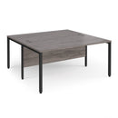 Dams Maestro 25 800mm deep back-to-back straight desks with bench legs in grey oak finish, showing the desk surface and leg design.