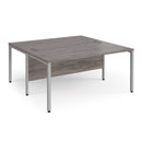 Dams Maestro 25 800mm deep back-to-back straight desks with bench legs in grey oak finish, showing the desk's modern design.
