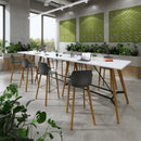 Unity circular dining table with solid oak legs by Dams, black finish, shown in a modern dining room setting.