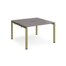 Dams Adapt back-to-back desks in grey oak finish with 600mm depth, featuring sleek tabletop and sturdy metal legs for office use.