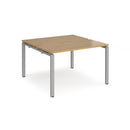 Dams Adapt Back to Back Desks with 600mm depth in oak finish, showcasing sleek wood surface and sturdy metal legs.