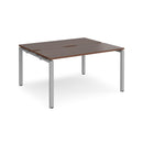 Dams Adapt back-to-back desks with 600mm depth in walnut finish, featuring sleek wood grain and modern office design.