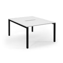 White Connex scalloped back-to-back desks by Dams, showing a modern office workspace with sleek design and smooth surfaces.