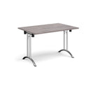 Grey oak rectangular folding leg table with curved foot rails by Dams, showcasing its sturdy design and smooth foldable legs.