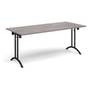 Dams rectangular folding leg table with curved foot rails in grey oak finish, showcasing its sturdy tabletop and foldable legs.