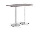 Dams Pisa rectangular poseur table with grey oak top and round chrome bases, ideal for modern communal or dining spaces.