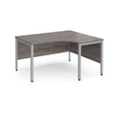 Dams Maestro 25 ergonomic desk with grey oak finish and bench leg, featuring a spacious workspace and modern design.