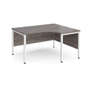 Dams Maestro 25 ergonomic desk with bench leg in grey oak finish, featuring a spacious work surface and modern design.