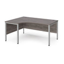 Dams Maestro 25 ergonomic desk with bench leg in grey oak finish, featuring a spacious work surface and modern design.