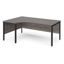 Dams Maestro 25 ergonomic desk with bench leg in grey oak finish, featuring a spacious workspace and modern design.