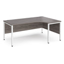 Dams Maestro 25 ergonomic desk with bench leg in grey oak finish, featuring a spacious workspace and modern design.