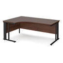 Dams Maestro 25 ergonomic desk with walnut finish and cable-managed leg, shown from the left side.