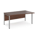 Walnut Maestro 25 Wave Desk with bench leg by Dams, showing the sleek curved tabletop and sturdy leg design.