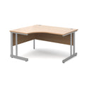 Dams Momento ergonomic desk with cantilever leg in beech wood finish, shown from the left side with smooth surface and sturdy design.